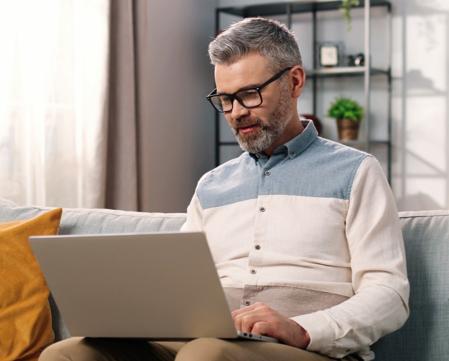 man looking at a laptop